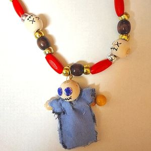 Voodoo doll on a Black, white and red necklace